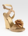 Adjustable, soft nubuck leather straps and an artful flower adornment add ladylike vibes to this timeless straw wedge. Straw wedge, 4 (100mm)Covered platform, ½ (15mm)Compares to a 3½ heel (90mm)Suede and straw upperLeather lining and solePadded insoleMade in SpainOUR FIT MODEL RECOMMENDS ordering true size. 