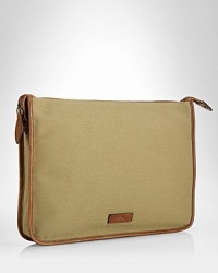 A sleek leather-trimmed canvas construction makes this portfolio a polished pick for stowing and transporting important documents. A sleek leather-trimmed canvas construction makes this portfolio a polished pick for stowing and transporting important documents.