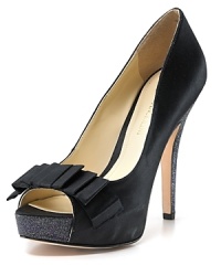 A glitter-covered platform and heel add unexpected touches to a towering peep toe pump from Enzio Angiolini, rendered in soirée-worthy satin. A glitter-covered platform and heel add unexpected touches to a towering peep toe pump from Enzio Angiolini, rendered in soirée-worthy satin.