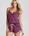 A striped romper with drawstring waist and bow accents for a stylish bedtime look.