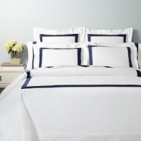 A classic navy sateen border trims this elegant boudoir sham by SFERRA, woven from super soft Egyptian cotton.