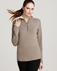 Play it cool in neutrals with this Nike half-zip top. A neon-pop collar lends a bold touch to the performance piece. Play it cool in neutrals with this Nike half-zip top. A neon-pop collar lends a bold touch to the performance piece.