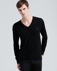 Contrast trim at the cuff and hem and the equestrian knight logo lend personality to this handsome and versatile merino V-neck from Burberry Brit. Contrast trim at the cuff and hem and the equestrian knight logo lend personality to this handsome and versatile merino V-neck from Burberry Brit.