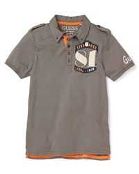 GUESS updates the traditional polo with cool military details and patchwork appliqué accents. GUESS updates the traditional polo with cool military details and patchwork appliqué accents.