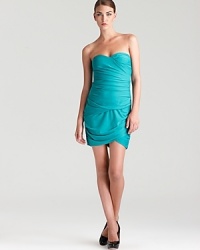 BCBGMAXAZRIA's mini Madge dress shows off with allover ruching and a sweetheart neckline. BCBGMAXAZRIA's mini Madge dress shows off with allover ruching and a sweetheart neckline.