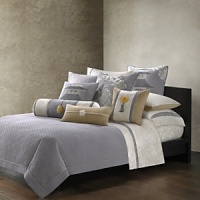In a palette of grey, pearl and gold, this bedding collection is inspired by an embroidered silk textile from Natori's archives. Stitching in a scallop-wave pattern creates a quilted effect on this grey sham. In a palette of grey, pearl and gold, this bedding collection is inspired by an embroidered silk textile from Natori's archives. Stitching in a scallop-wave pattern creates a quilted effect on this grey sham.