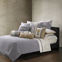 In a palette of grey, pearl and gold, this bedding collection is inspired by an embroidered silk textile from Natori's archives. Stitching in a scallop-wave pattern creates a quilted effect on this grey sham.