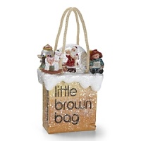 Santa reviews his nice list surrounded by toys, all atop the iconic little brown bag decked in glittering snow. Santa reviews his nice list surrounded by toys, all atop the iconic little brown bag decked in glittering snow.