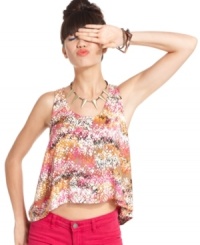 Get your summer color fix! Splatters of vivid hues paint the prettiest picture on this asymmetrical blouse from Material Girl. Get your summer color fix! Splatters of vivid hues paint the prettiest picture on this asymmetrical blouse from Material Girl.