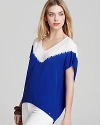 Rendered in supple silk, this GUESS top adds a pop of color to your everyday wardrobe. Rendered in supple silk, this GUESS top adds a pop of color to your everyday wardrobe.