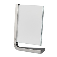 Movie vertical frames by Nambé. Designed by Neil Cohen for Nambé, these sleek metal frames feature a metal base and two squares of glass to protect your pictures. The movie frame is a wonderful gift for the home or office. Movie vertical frames by Nambé. Designed by Neil Cohen for Nambé, these sleek metal frames feature a metal base and two squares of glass to protect your pictures. The movie frame is a wonderful gift for the home or office.