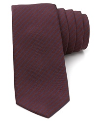 An understated stripe design runs across a skinny width silhouette for a thoroughly modern design from Theory. An understated stripe design runs across a skinny width silhouette for a thoroughly modern design from Theory.