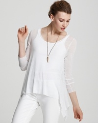 Rendered in a light-as-air knit, this Eileen Fisher tunic is designed with a stylish dipped hem for full coverage over your favorite leggings. Rendered in a light-as-air knit, this Eileen Fisher tunic is designed with a stylish dipped hem for full coverage over your favorite leggings.
