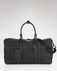 Travel in style with Burberry--this check printed holdall is polished and practical. Travel in style with Burberry--this check printed holdall is polished and practical.