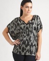 A stunning pattern of sequins creates a sophisticated shimmer on this shapely dolman sleeve top of silky modal knit.Scoop neckline with center notchShort dolman sleevesPieced waistContrast pipingAbout 28 from shoulder to hemModalSpot cleanImported