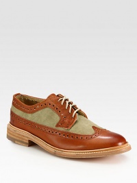 Classic wingtip style gets a contemporary update with contrasting textures, rendered with a smooth, genuine leather finish.Leather/canvas upperLeather liningPadded insoleLeather soleImported