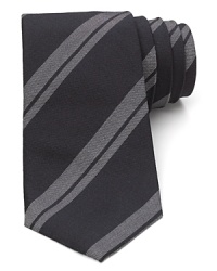 A handsome stripe tie is rendered with a narrower width for a balanced approach to modern trends and classic refinement. A handsome stripe tie is rendered with a narrower width for a balanced approach to modern trends and classic refinement.