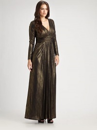 Shimmering, floor-length gown with a ruched silhouette and flattering Empire waist. Gathered v-neckRuched empire waistLong sleevesInvisible back zipperAbout 45 from natural waistFully lined92% polyester/8% spandexDry cleanMade in USA of imported fabric Shimmering, floor-length gown with a ruched silhouette and flattering Empire waist. Gathered v-neckRuched empire waistLong sleevesInvisible back zipperAbout 45 from natural waistFully lined92% polyester/8% spandexDry cleanMade in USA of imported fabric
