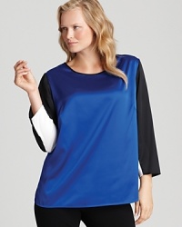 Define modern design in an effortless VINCE CAMUTO blouse shining with searing blocks of bod color.