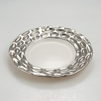 Precious metals and porcelain capture the timeless shifting of ocean, wind and sand into lasting impressions inspired by the dunes of Truro, Cape Cod. Precious metals and porcelain capture the timeless shifting of ocean, wind and sand into lasting impressions inspired by the dunes of Truro, Cape Cod.