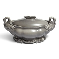An elegant, handmade tureen features feathered ducks and a scalloped edge with a leaf handle. Handmade in Portugal, each tureen has subtle variations in color. An elegant, handmade tureen features feathered ducks and a scalloped edge with a leaf handle. Handmade in Portugal, each tureen has subtle variations in color.
