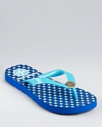 A bright, patterned footbed lends graphic punch to a summery pair of Tory Burch flip flops. A bright, patterned footbed lends graphic punch to a summery pair of Tory Burch flip flops.