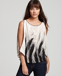 Give them the cold shoulder in this provocative printed Akiko top that features alluring open slit sleeves in pure silk. Give them the cold shoulder in this provocative printed Akiko top that features alluring open slit sleeves in pure silk.