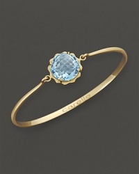 A faceted blue topaz adds brilliant color to gleaming 18K yellow gold. By Carelle. A faceted blue topaz adds brilliant color to gleaming 18K yellow gold. By Carelle.