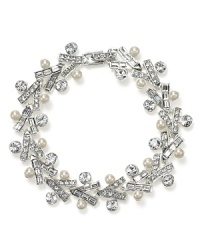 A sleek melding of classic and dramatic. This glittering Carolee Lux bracelet captures this season's opulent mood with an all-around of crystals and pearl stations. A sleek melding of classic and dramatic. This glittering Carolee Lux bracelet captures this season's opulent mood with an all-around of crystals and pearl stations.