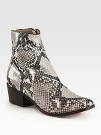 Impeccably-crafted timeless silhouette of luxe python with a stacked heel and side zip. Stacked heel, 2 (50mm)Python upperSide zipLeather liningRubber and leather solePadded insoleMade in Italy Impeccably-crafted timeless silhouette of luxe python with a stacked heel and side zip. Stacked heel, 2 (50mm)Python upperSide zipLeather liningRubber and leather solePadded insoleMade in Italy