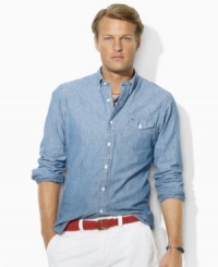 Designed in a trim, modern fit, a cotton chambray shirt exudes rugged, timeworn appeal with traditional tailored details. Designed in a trim, modern fit, a cotton chambray shirt exudes rugged, timeworn appeal with traditional tailored details.