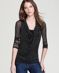 Delve into the darker side of style as sheer mesh and subtle sparkle infuse this Karen Kane top with serious daytime drama. Delve into the darker side of style as sheer mesh and subtle sparkle infuse this Karen Kane top with serious daytime drama.