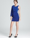 Allover draping lends a chic look to BCBGMAXAZRIA's short dress, showcasing a dramatic one-sleeve silhouette.