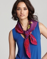 A boldly colored floral print in vivid red and lilac pops off of a vibrant violet background in this eye-catching, vintage-look Charlotte Sparre scarf. A boldly colored floral print in vivid red and lilac pops off of a vibrant violet background in this eye-catching, vintage-look Charlotte Sparre scarf.