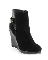 Cole Haan injects a high dose of fashion into abbreviated suede booties on patent wedges accented with embossed patent detailing and silver hardware. Cole Haan injects a high dose of fashion into abbreviated suede booties on patent wedges accented with embossed patent detailing and silver hardware.