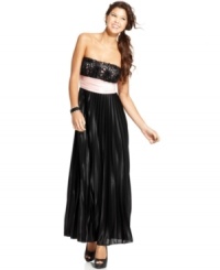 Make a splash in this strapless gown from Speechless! Rosette detailing and a flowing skirt of pleats come together in elegant form. Make a splash in this strapless gown from Speechless! Rosette detailing and a flowing skirt of pleats come together in elegant form.