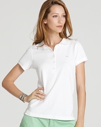 This Vineyard Vines polo updates the classic silhouette in a fitted shape with their signature whale logo embroidered at the chest. This Vineyard Vines polo updates the classic silhouette in a fitted shape with their signature whale logo embroidered at the chest.