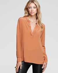 Nothing feels more luxurious than pure silk against your skin--we're obsessed with this Vince blouse for its simple structure and alluring V neck. Nothing feels more luxurious than pure silk against your skin--we're obsessed with this Vince blouse for its simple structure and alluring V neck.