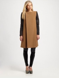 This dynamic silhouette boasts a clean, asymmetric-front offset by rich, leather-like sleeves for the perfect mix of minimalist and contemporary edge.JewelneckConcealed three-button frontContrast sleevesOn-seam slash pocketsSwing backAbout 40 from shoulder to hemPolyesterDry cleanImportedModel shown is 5'8½ (174cm) wearing US size Small. This dynamic silhouette boasts a clean, asymmetric-front offset by rich, leather-like sleeves for the perfect mix of minimalist and contemporary edge.JewelneckConcealed three-button frontContrast sleevesOn-seam slash pocketsSwing backAbout 40 from shoulder to hemPolyesterDry cleanImportedModel shown is 5'8½ (174cm) wearing US size Small.