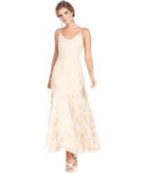 Xscape's gown is feminine with beaded flourishes through the bodice and hips and a flowing, ethereal applique through the skirt. Xscape's gown is feminine with beaded flourishes through the bodice and hips and a flowing, ethereal applique through the skirt.