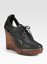 Lace-up pebbled leather ankle boot has a wooden wedge, edgy cutout sides and intricate woven details at the toe. Wooden wedge, 4 (100mm)Wooden platform, 1 (25mm)Compares to a 3 heel (75mm)Leather upperLeather liningRubber solePadded insoleImportedOUR FIT MODEL RECOMMENDS ordering one half size up as this style runs small. Lace-up pebbled leather ankle boot has a wooden wedge, edgy cutout sides and intricate woven details at the toe. Wooden wedge, 4 (100mm)Wooden platform, 1 (25mm)Compares to a 3 heel (75mm)Leather upperLeather liningRubber solePadded insoleImportedOUR FIT MODEL RECOMMENDS ordering one half size up as this style runs small.