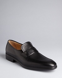 A traditional penny loafer design rendered in exceptionally smooth leather grounds your look in classic luxury. A traditional penny loafer design rendered in exceptionally smooth leather grounds your look in classic luxury.