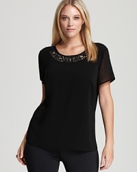 Take your daily repertoire to the dark side with a decadently embellished DKNYC Plus top. Statement shine, surprising texture and effortless styling make for a luxe everyday look. Take your daily repertoire to the dark side with a decadently embellished DKNYC Plus top. Statement shine, surprising texture and effortless styling make for a luxe everyday look.