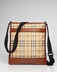 Tall, plaid and useful, this crossbody messenger bag features Burberry's signature plaid embellished with brown leather trim and a black crossbody strap. Tall, plaid and useful, this crossbody messenger bag features Burberry's signature plaid embellished with brown leather trim and a black crossbody strap.