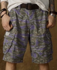 A rugged camo print accents these faded and frayed cargo shorts for an all-purpose, military-inspired look. A rugged camo print accents these faded and frayed cargo shorts for an all-purpose, military-inspired look.