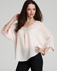Intricate crochet glorifies a diaphanous XCVI tunic for pure ethereal elegance. Play up the blush-worthy hue with layered neutrals for a subtle statement. Intricate crochet glorifies a diaphanous XCVI tunic for pure ethereal elegance. Play up the blush-worthy hue with layered neutrals for a subtle statement.