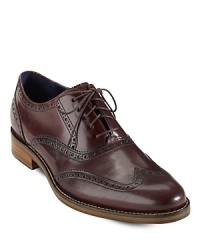 Classic design meets modern innovation with this unique wingtip oxford from Cole Haan, cushioned with Nike Air technology to ensure a comfortable wear from sunrise to sunset. Classic design meets modern innovation with this unique wingtip oxford from Cole Haan, cushioned with Nike Air technology to ensure a comfortable wear from sunrise to sunset.