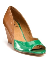 With subtle stitched trim and patent accents, Kelsi Dagger's Genelle wedges offer trend-right style in a chic silhouette. With subtle stitched trim and patent accents, Kelsi Dagger's Genelle wedges offer trend-right style in a chic silhouette.