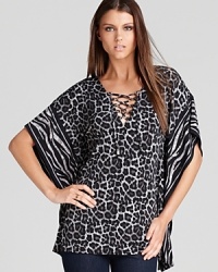 Enlivened by a graphic rush of animal prints, this MICHAEL Michael Kors top lends exotic inspiration to your everyday look. Tame the style with sleek denim for a roaring fashion statement. Enlivened by a graphic rush of animal prints, this MICHAEL Michael Kors top lends exotic inspiration to your everyday look. Tame the style with sleek denim for a roaring fashion statement.