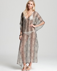 Echo's dramatic caftan coverup features a luxe bohemian print on ethereal semi-sheer material. Paired with flat sandals and some glittering bangles, it pulls your swim style together. Echo's dramatic caftan coverup features a luxe bohemian print on ethereal semi-sheer material. Paired with flat sandals and some glittering bangles, it pulls your swim style together.